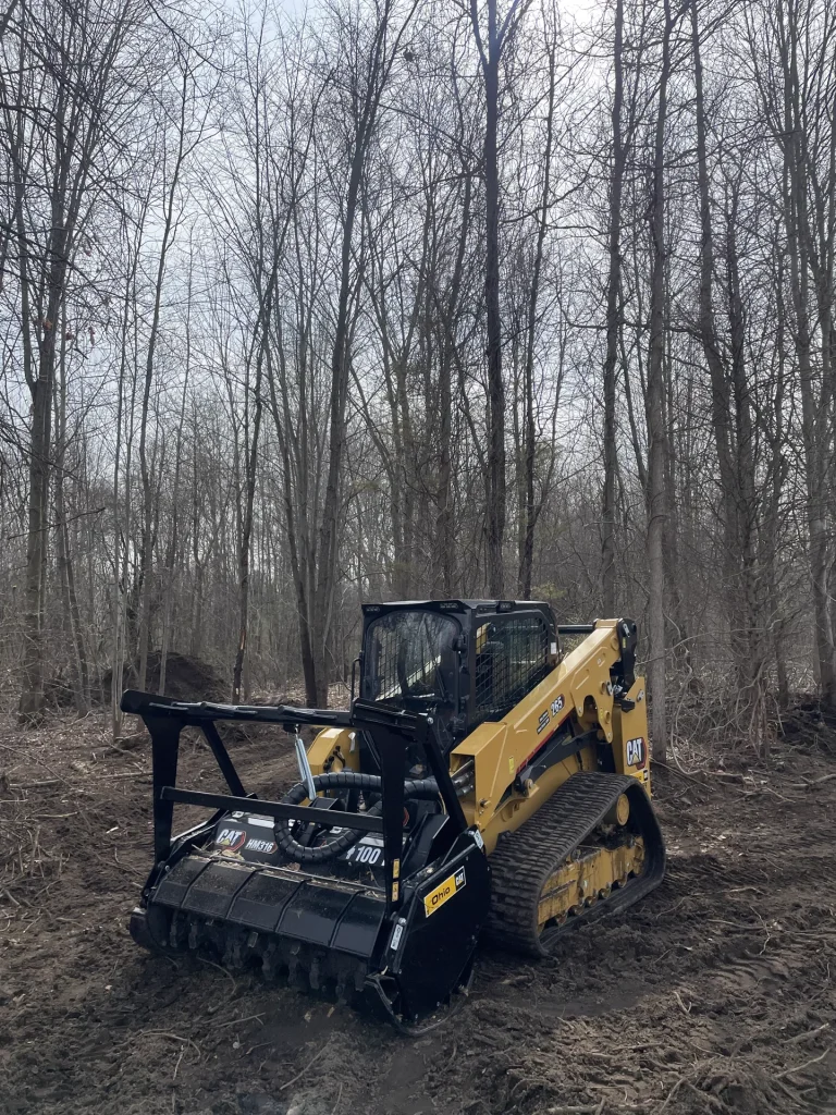 Better Way Land Management LLC CAT 265 compact track loader with HM316 mulcher performing forestry mulching in Northwest Ohio woodland